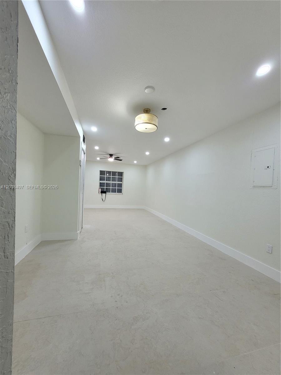 A spacious, empty room features light-colored tile flooring, white walls, a ceiling fan, and recessed lighting — 18000 SW 175th St # 18002, Miami FL 33187, MIAMI, FL