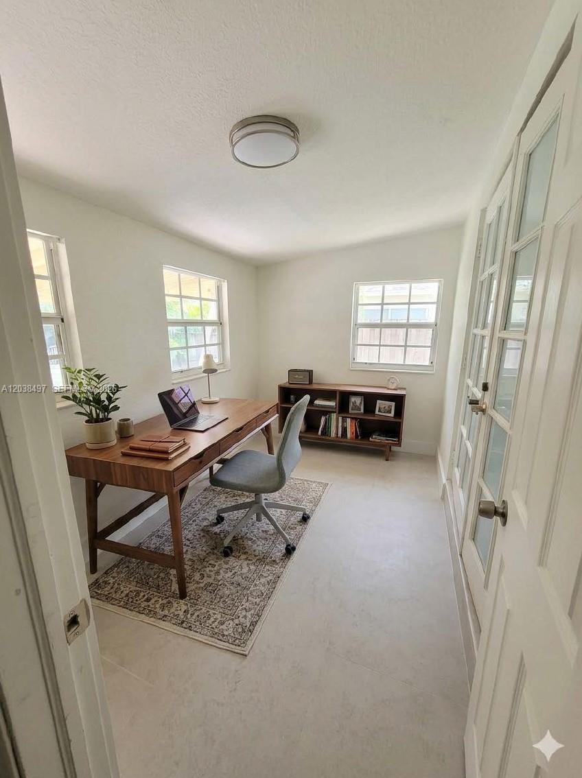 A bedroom features a wooden bed frame, two nightstands, and a rug on light flooring — 18000 SW 175th St # 18002, Miami FL 33187, MIAMI, FL