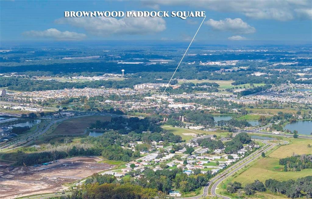 This aerial view shows a suburban landscape with a designated town square and surrounding neighborhoods — LOT 52 BLK C LEXINGTON- CIRCLE, WILDWOOD, FL