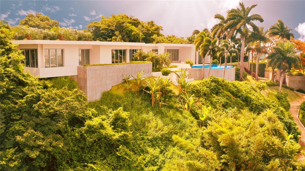 A modern white house with a swimming pool sits on a lush, tree-covered hillside — URB. LA LOMITA CALLE VISTA LINDA, GUAYNABO, PR