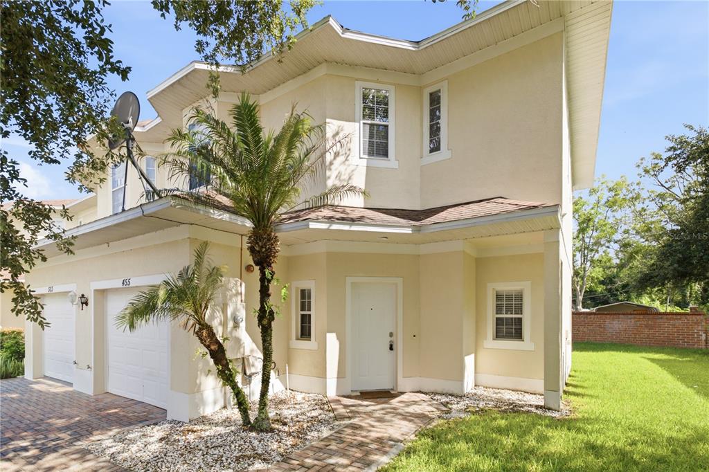 A two-story beige stucco house with a white front door and a brick paver driveway — 455 WESTPOINT GARDEN CIRCLE, WINTER GARDEN, FL