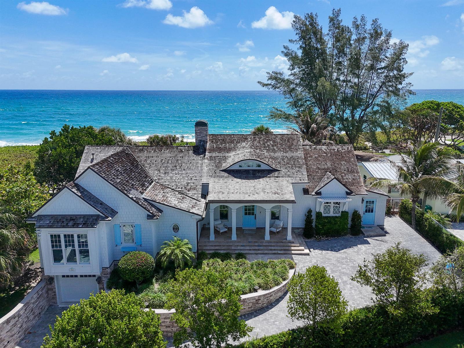 An aerial view of a coastal home with a shingled roof and a paved driveway — 282 Celestial Way, Juno Beach FL 33408, JUNO BEACH, FL