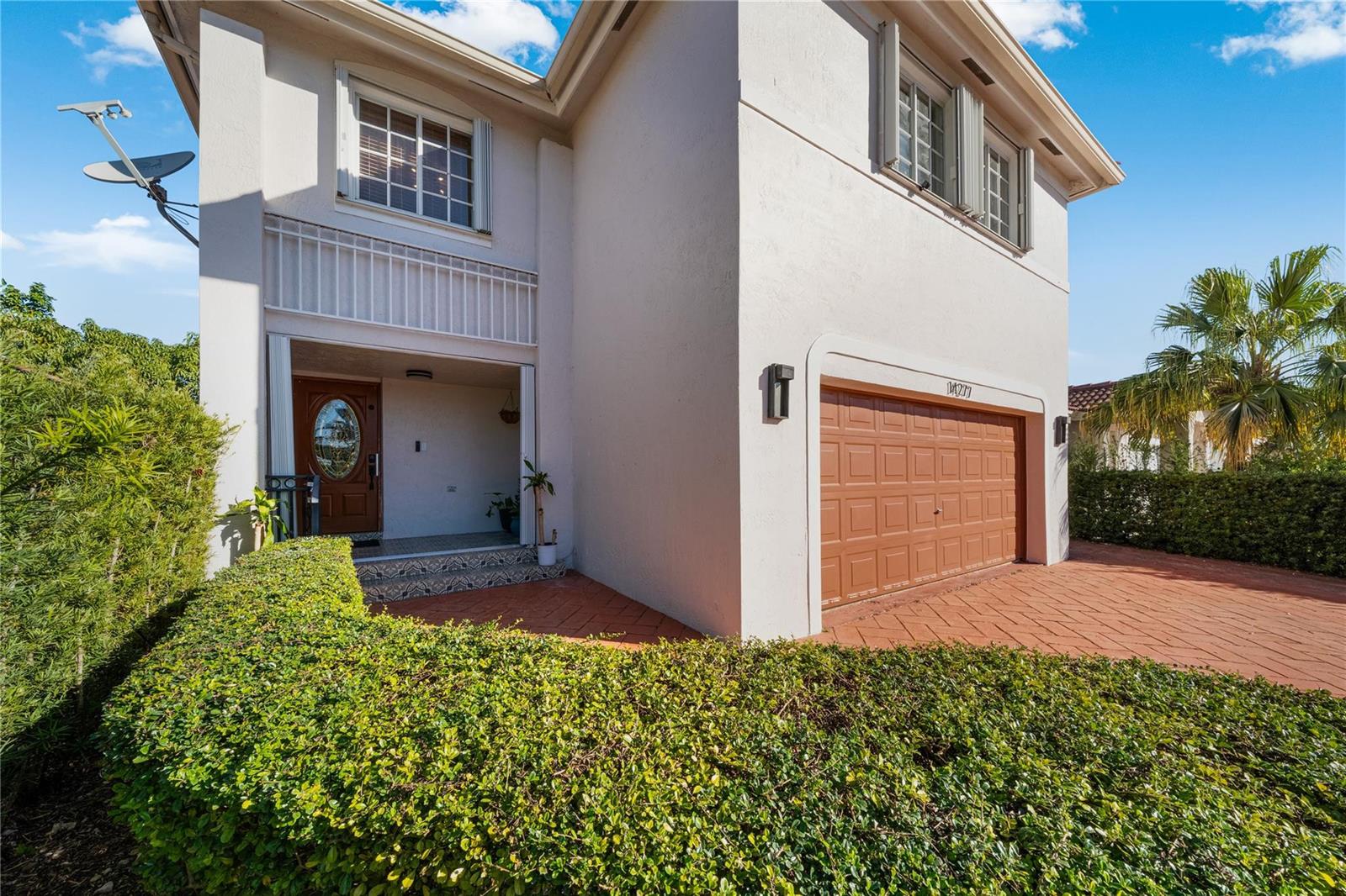 A backyard patio features a large wooden pergola, stamped concrete flooring, and a wooden fence — 14277 SW 177th Street, Miami FL 33177, MIAMI, FL