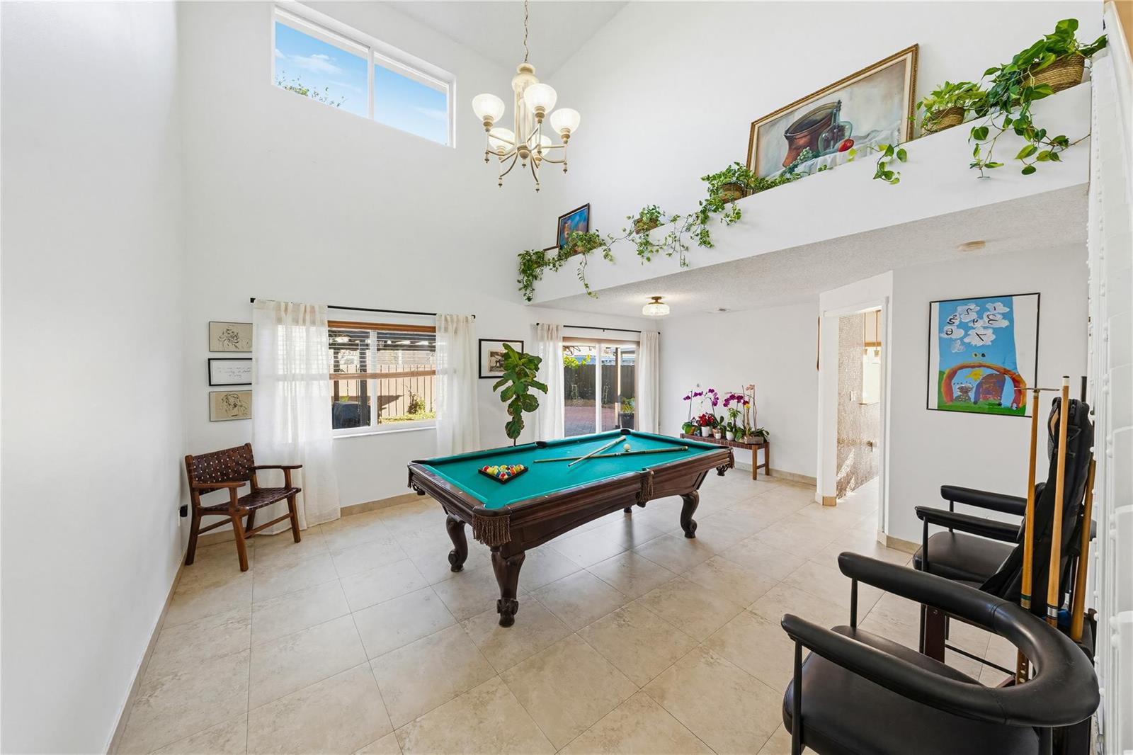 A backyard patio features a covered pergola, stamped concrete flooring, and a wooden privacy fence — 14277 SW 177th Street, Miami FL 33177, MIAMI, FL