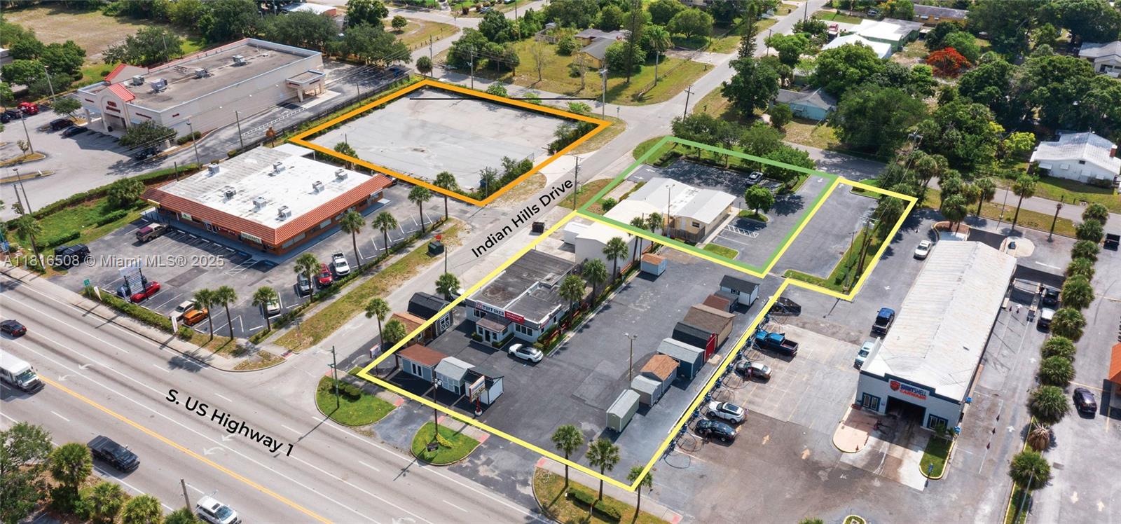 This aerial view shows commercial properties and parking lots outlined in colored borders — 2402 S US Highway 1, Fort Pierce FL 34982, FORT PIERCE, FL