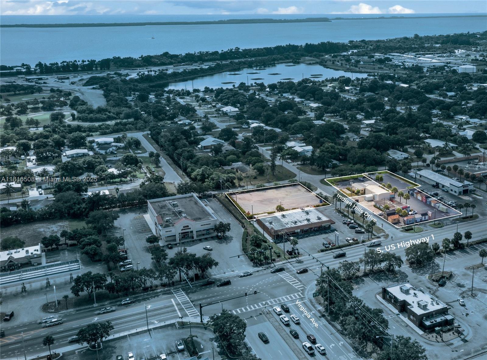 An aerial view shows commercial properties and a vacant lot near a major intersection — 2402 S US Highway 1, Fort Pierce FL 34982, FORT PIERCE, FL