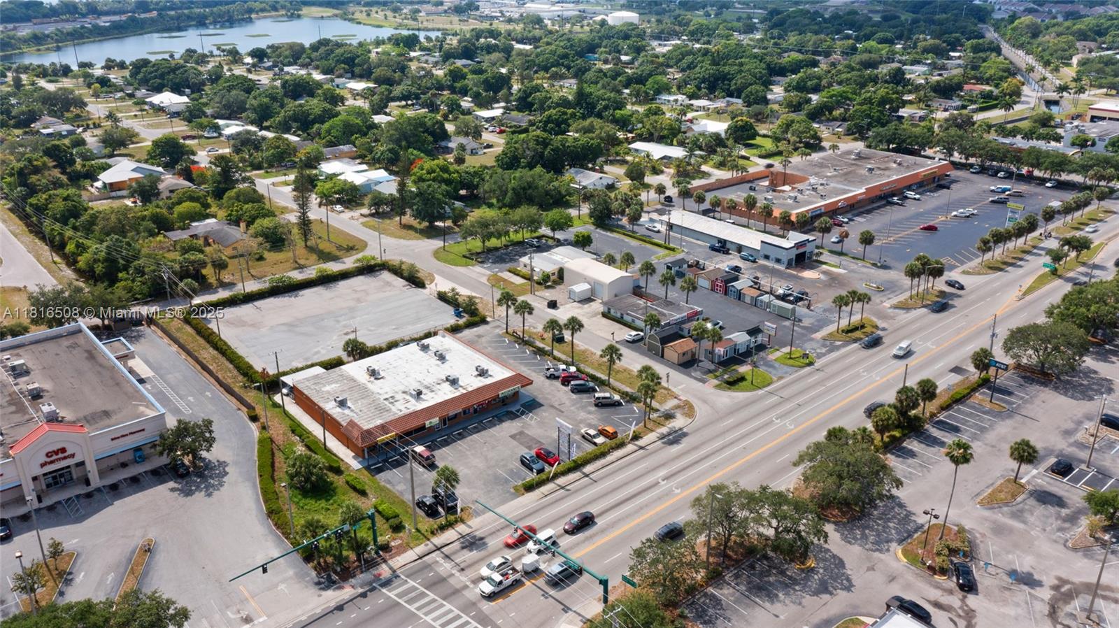 An aerial view shows a commercial strip center with parking lots near a busy road — 2402 S US Highway 1, Fort Pierce FL 34982, FORT PIERCE, FL