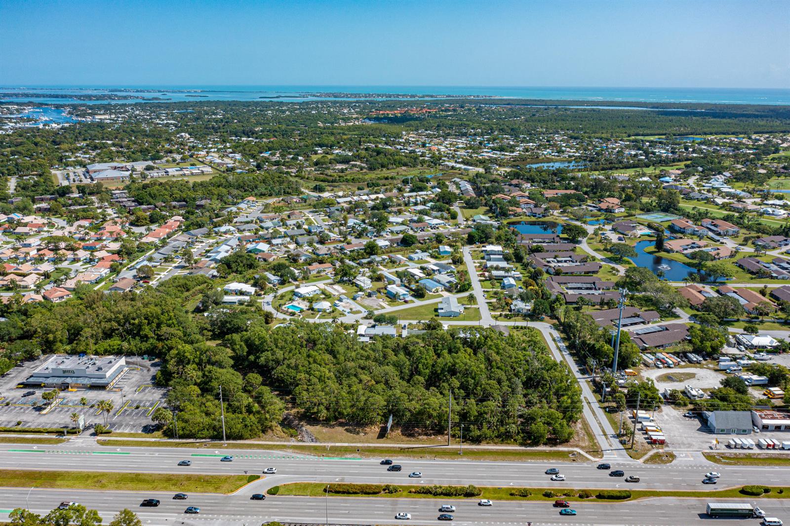 An aerial view shows a residential neighborhood, a wooded area, and a multi-lane highway — 0 SE Federal Highway, Stuart FL 34997, STUART, FL