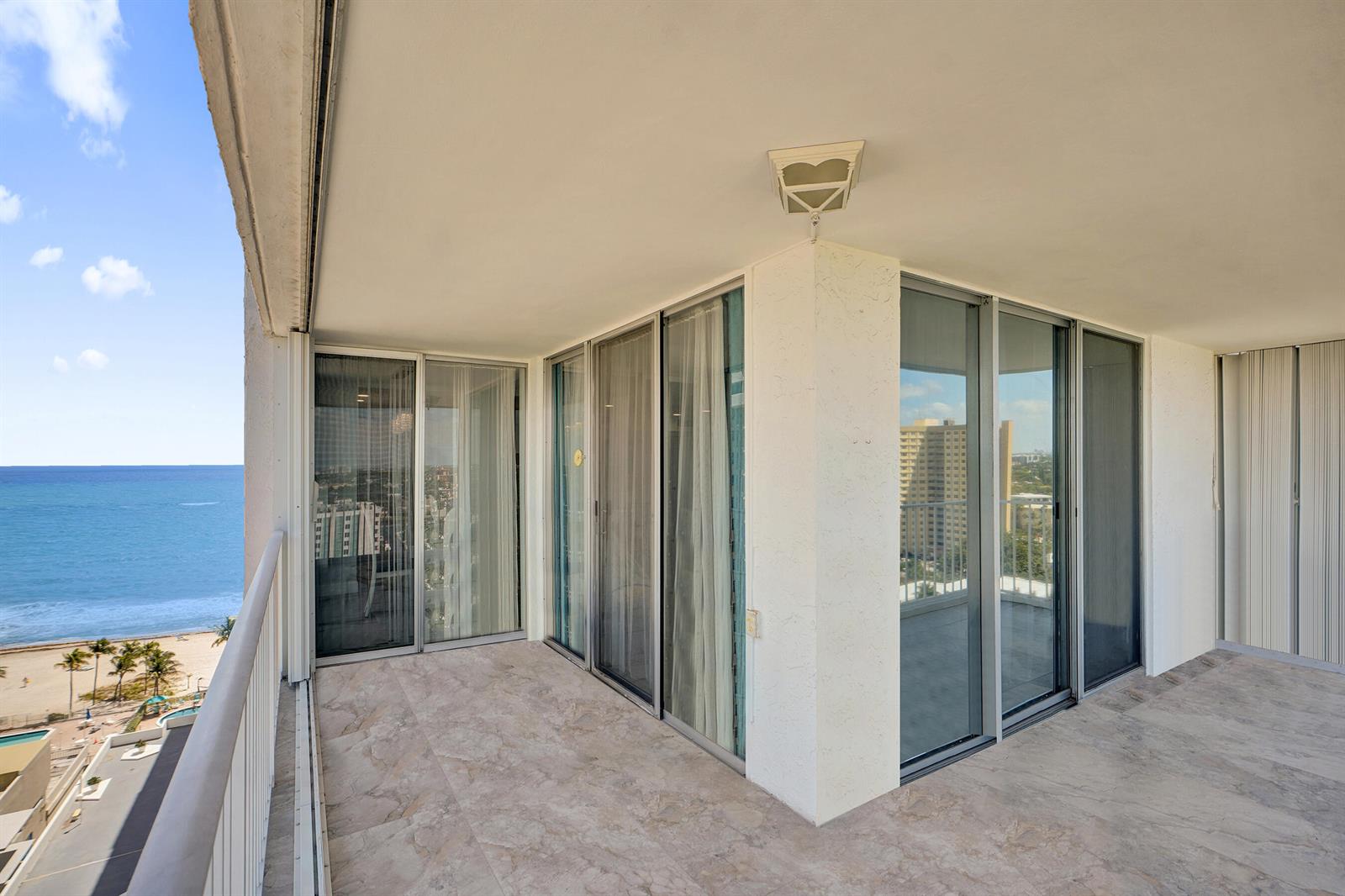 A balcony with tile flooring overlooks the ocean and features sliding glass door entrances — 1010 S Ocean Boulevard # 2009, Pompano Beach FL 33062, POMPANO BEACH, FL
