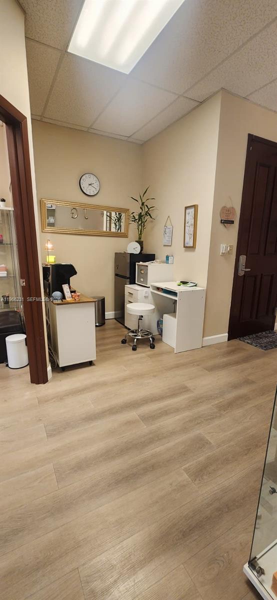 A small office or break area features light wood flooring, white furniture, and a wall mirror — orange dr 12505, Davie FL 33330, DAVIE, FL