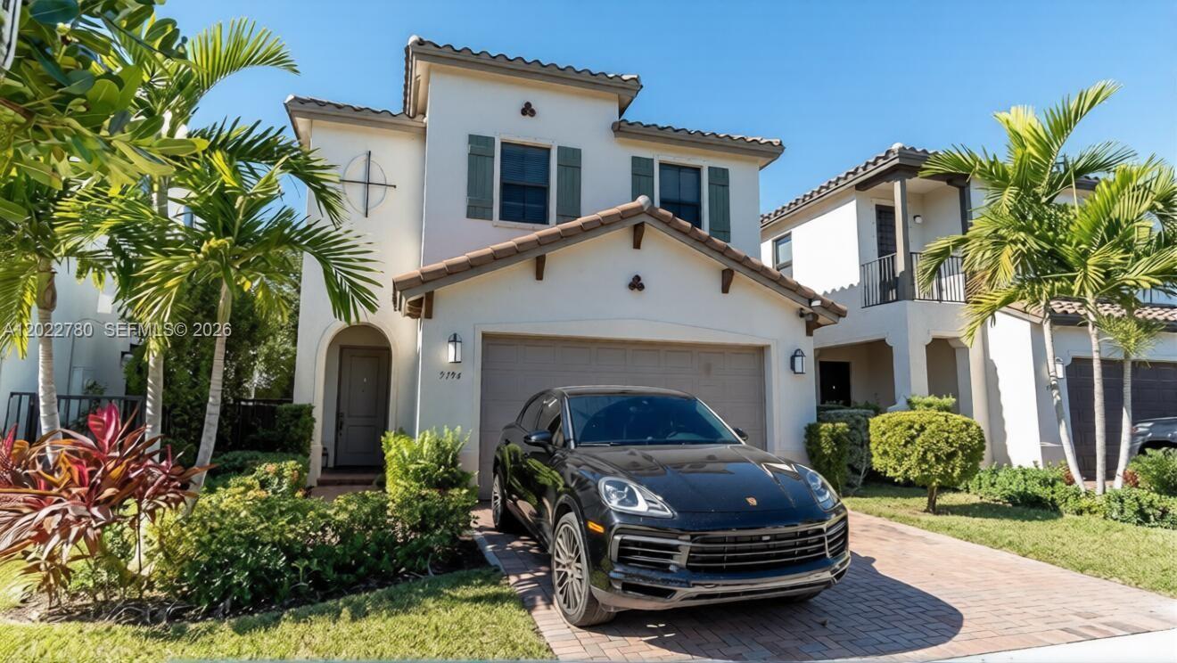 A two-story house with a beige stucco exterior, a tile roof, and a black SUV parked outside — 9794 W 34th Ct # 0, Hialeah FL 33018, HIALEAH, FL