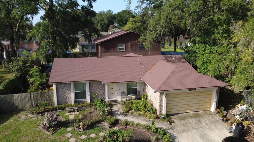 An aerial view of a single-story house with a stone facade and a brown roof — 5832 ELON DRIVE, ORLANDO, FL