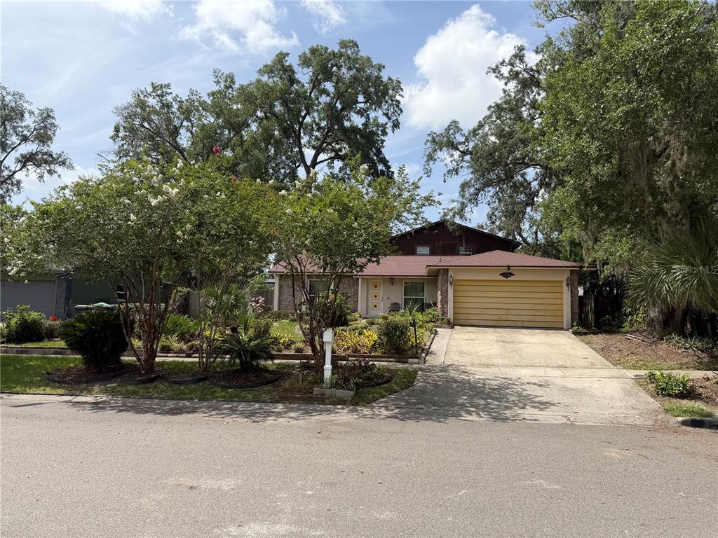 A single-story house with a two-car garage and a landscaped front yard — 5832 ELON DRIVE, ORLANDO, FL