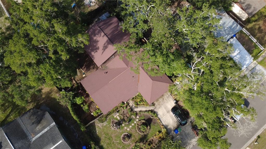 An aerial view shows a house with a brown roof, surrounded by trees and landscaping — 5832 ELON DRIVE, ORLANDO, FL