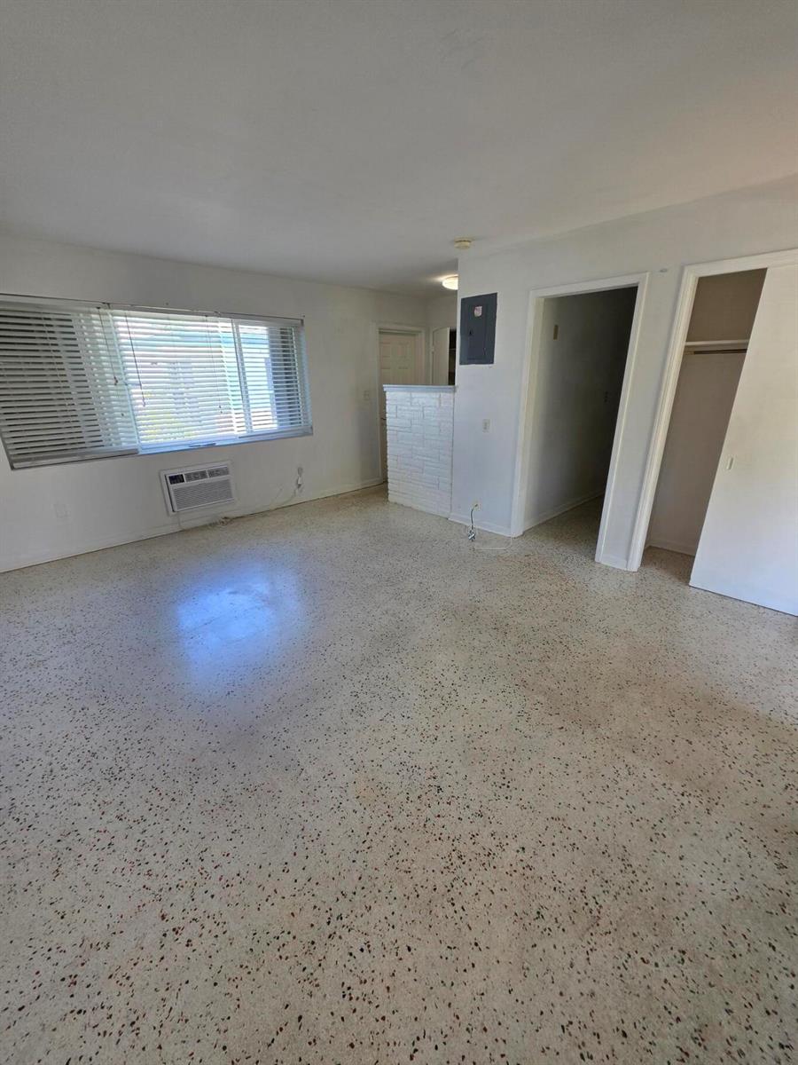 An empty room features white walls, a window with blinds, and speckled terrazzo flooring — 1216 Cabana Road # 1a, Singer Island FL 33404, SINGER ISLAND, FL