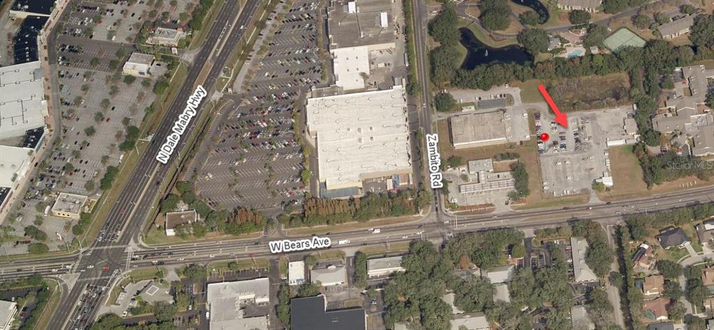 An aerial view shows a commercial property with a parking lot near a major intersection — 3603 W BEARSS AVENUE, TAMPA, FL