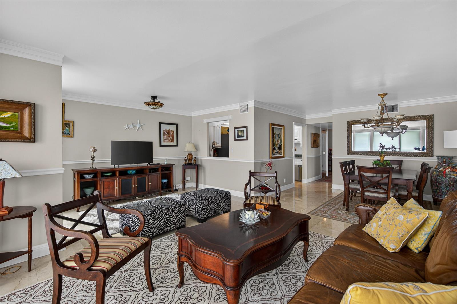 A living room and dining area with neutral walls, tile floors, and traditional wood furniture — 531 N Ocean Boulevard # 1811, Pompano Beach FL 33062, POMPANO BEACH, FL
