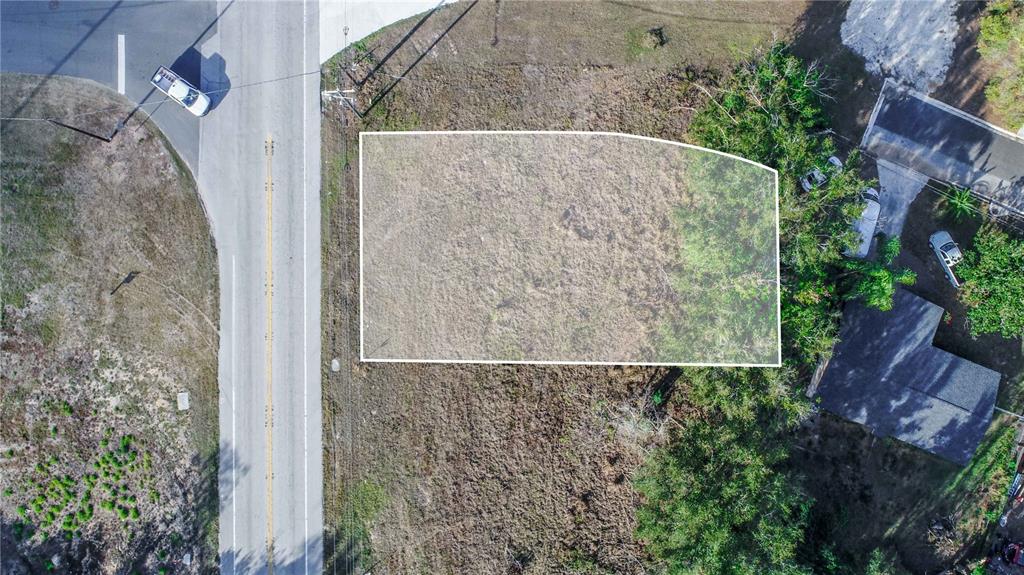 An aerial view shows a rectangular, highlighted vacant lot adjacent to a paved road — SR-17 SCENIC HIGHWAY N, HAINES CITY, FL