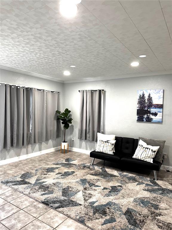 A living room features gray curtains, a black futon, and a geometric patterned area rug — 5829 12TH STREET, ZEPHYRHILLS, FL