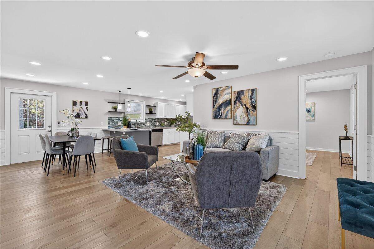An open-concept living and dining area features light wood flooring, a ceiling fan, and kitchen — 262 Easy Street, Sebastian FL 32958, SEBASTIAN, FL