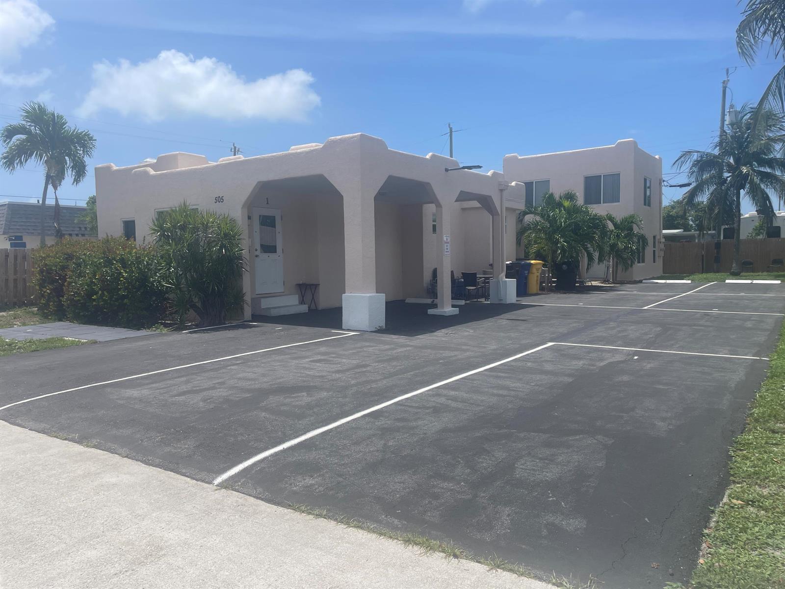 A single-story stucco building with a covered entryway and an adjacent parking lot — 505 24th Avenue N, FL 33460, FL