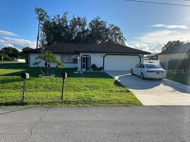 A single-story house with a white exterior, dark roof, and a white car in the driveway — 602 MESILLA DRIVE, KISSIMMEE, FL