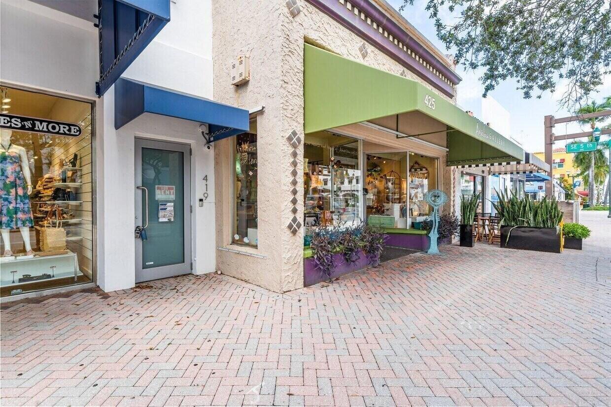 A street-level view of two storefronts with brick pavers and green and blue awnings — 419 E Atlantic Avenue, Delray Beach FL 33483, DELRAY BEACH, FL