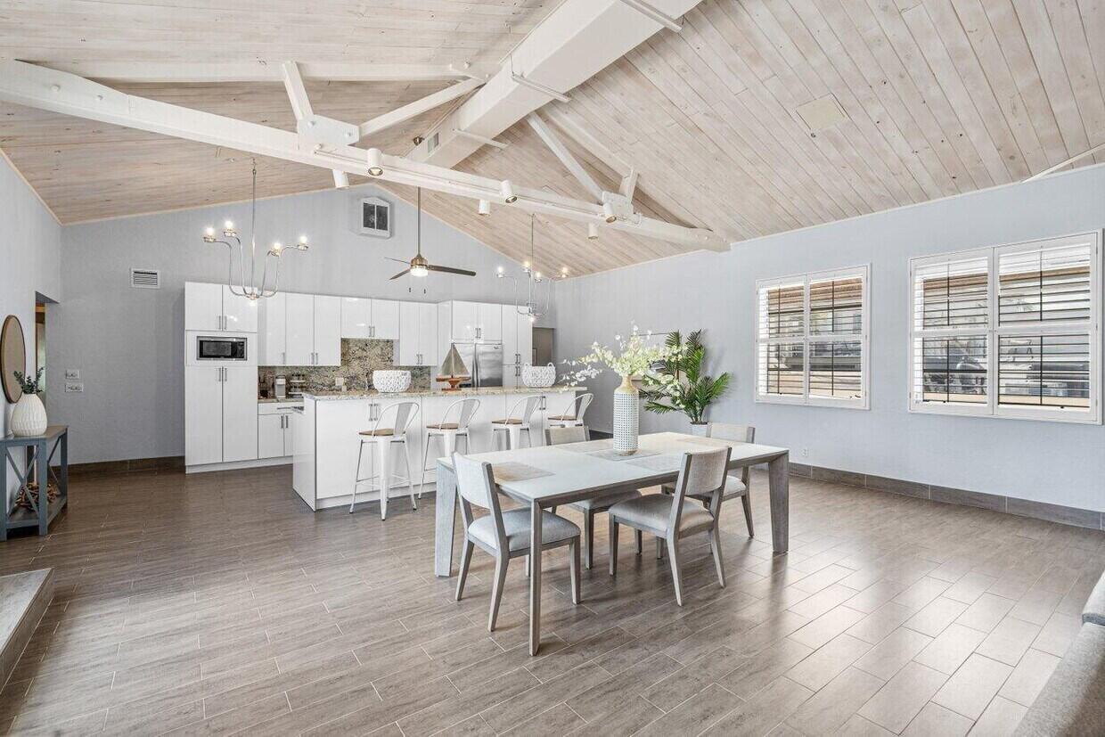 A bright open-concept kitchen and dining area with vaulted wood ceilings and tile flooring — 419 E Atlantic Avenue, Delray Beach FL 33483, DELRAY BEACH, FL