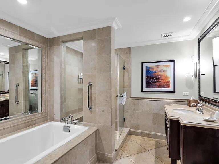 A bathroom features a white soaking tub, a glass-enclosed shower, and a dark wood vanity — 81801 Overseas Highway Highway # 714, Islamorada FL 33036, ISLAMORADA, FL
