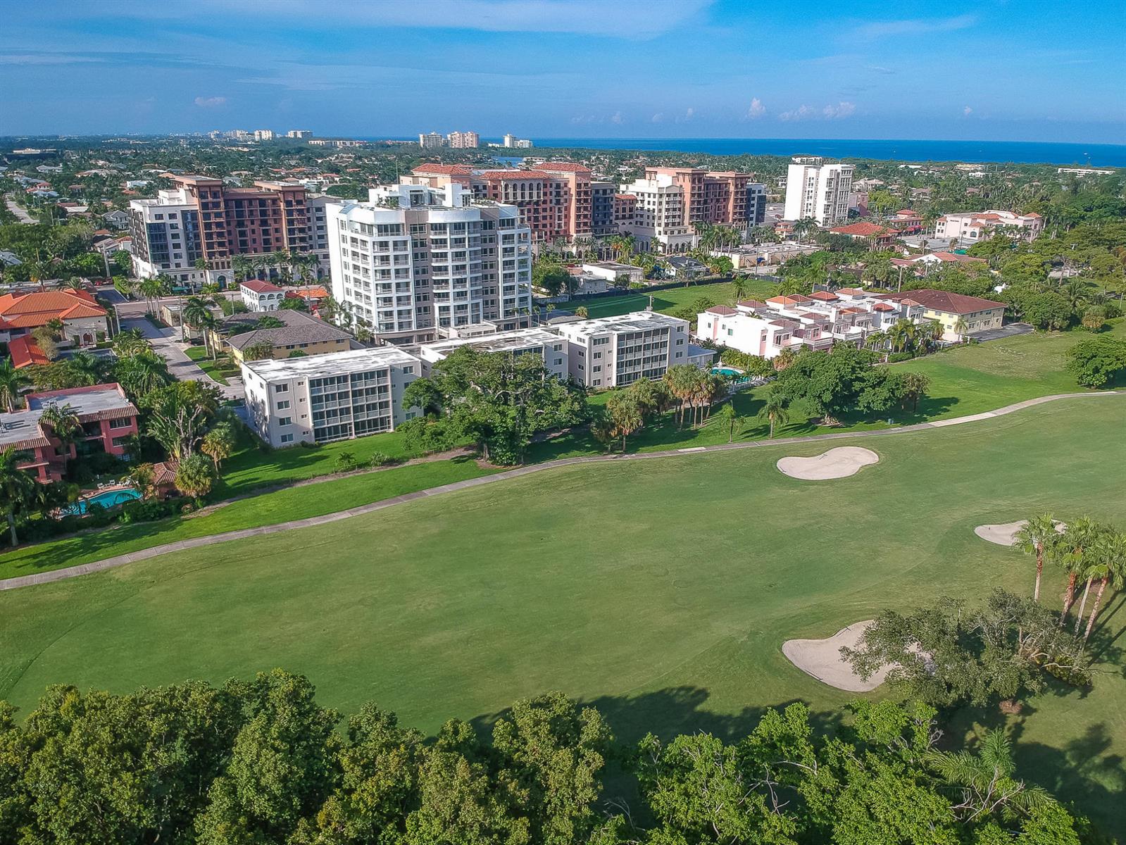 An aerial view shows a golf course fairway bordered by multi-story residential buildings and trees — 300 E Royal Palm Road # 0420, Boca Raton FL 33432, BOCA RATON, FL