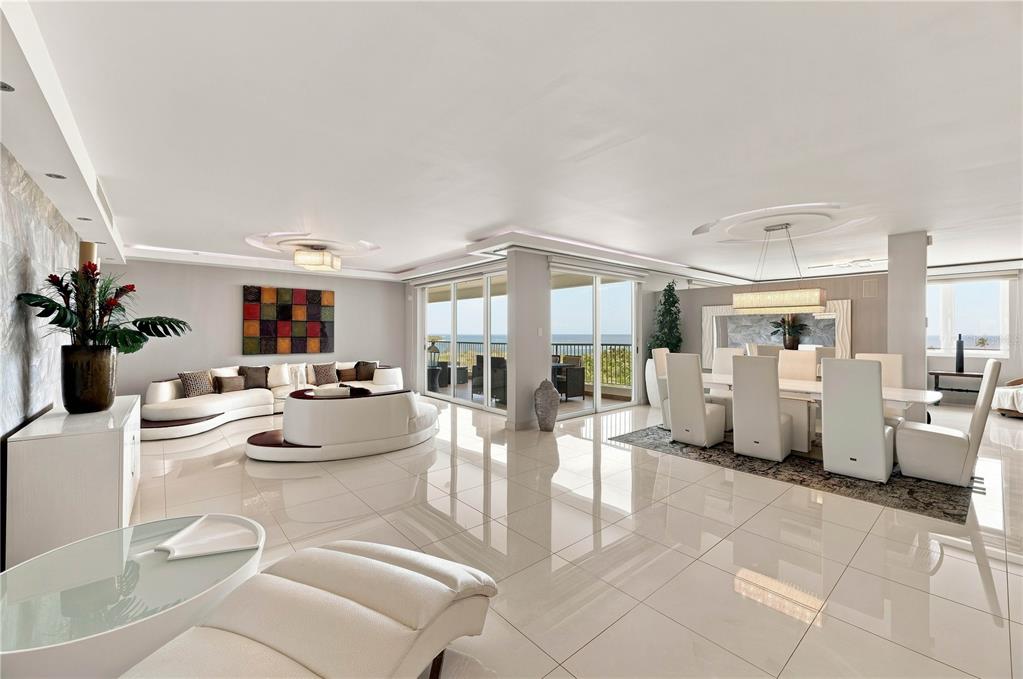 A spacious open-concept living and dining area with white tile floors and ocean views — 145 OLIVINE STREET UNIT PH-571, VEGA ALTA, PR