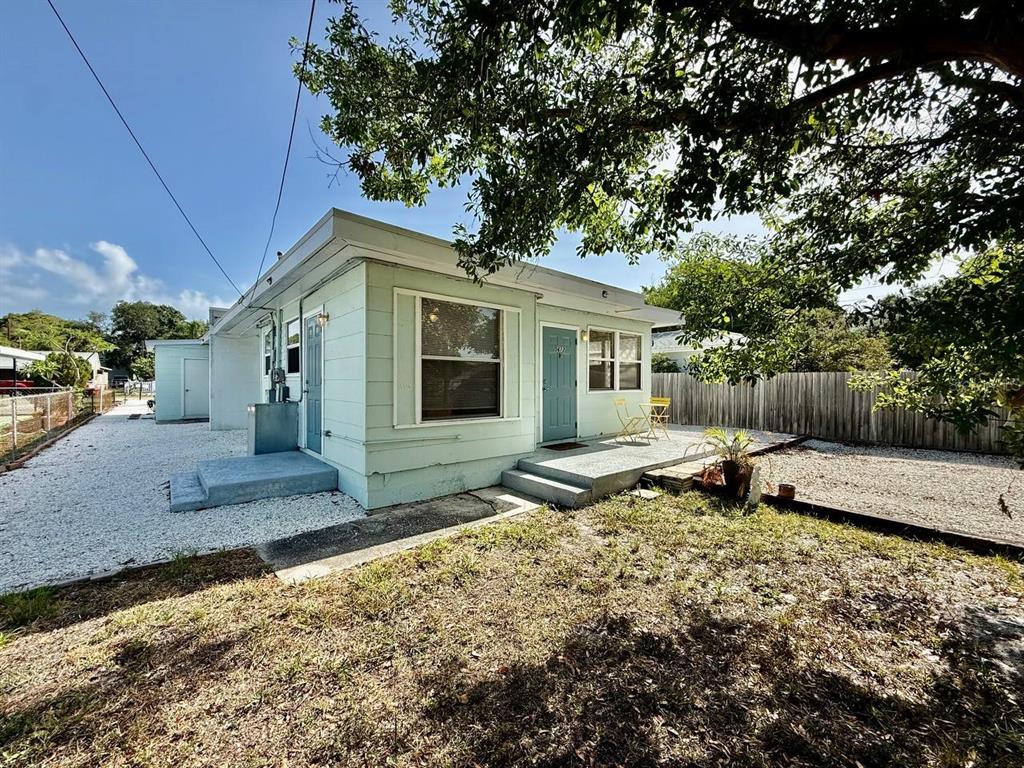 A light green single-story house with a gravel yard and a small concrete patio — 5612 18TH AVENUE S, ST PETERSBURG, FL