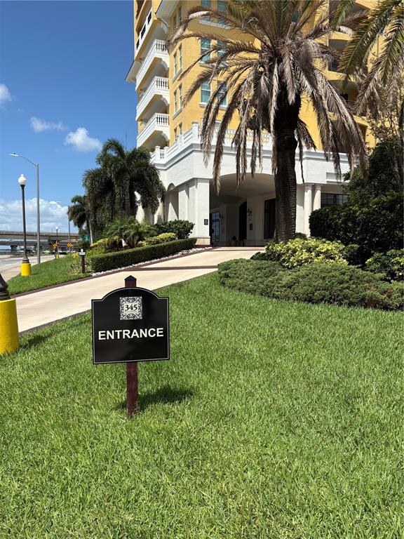 A tiered mosaic tile fountain sits outdoors between two columns with a hospital in the background — 345 BAYSHORE BOULEVARD UNIT 403, TAMPA, FL