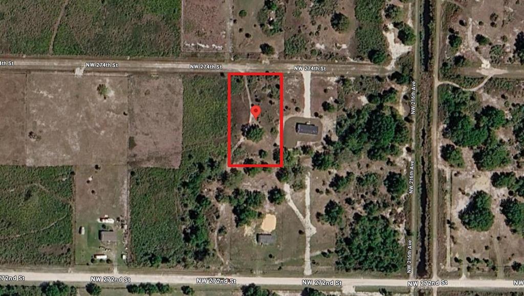 This aerial map shows a rectangular plot of land highlighted in red near a road — 21764 NW 274TH STREET, OKEECHOBEE, FL
