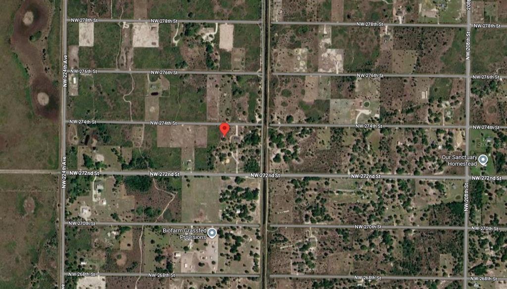 This is a satellite map view showing a residential property marked with a red pin — 21764 NW 274TH STREET, OKEECHOBEE, FL