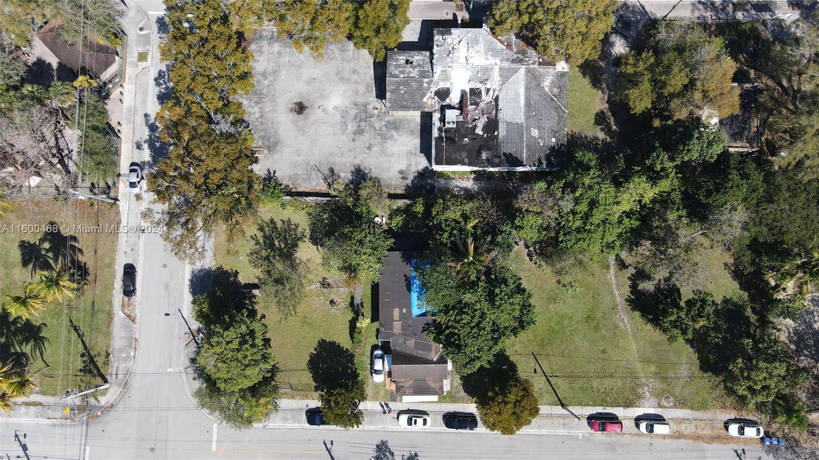 An aerial view shows two adjacent properties with a large parking area and a house — 3373 Thomas Ave, Miami FL 33133, MIAMI, FL