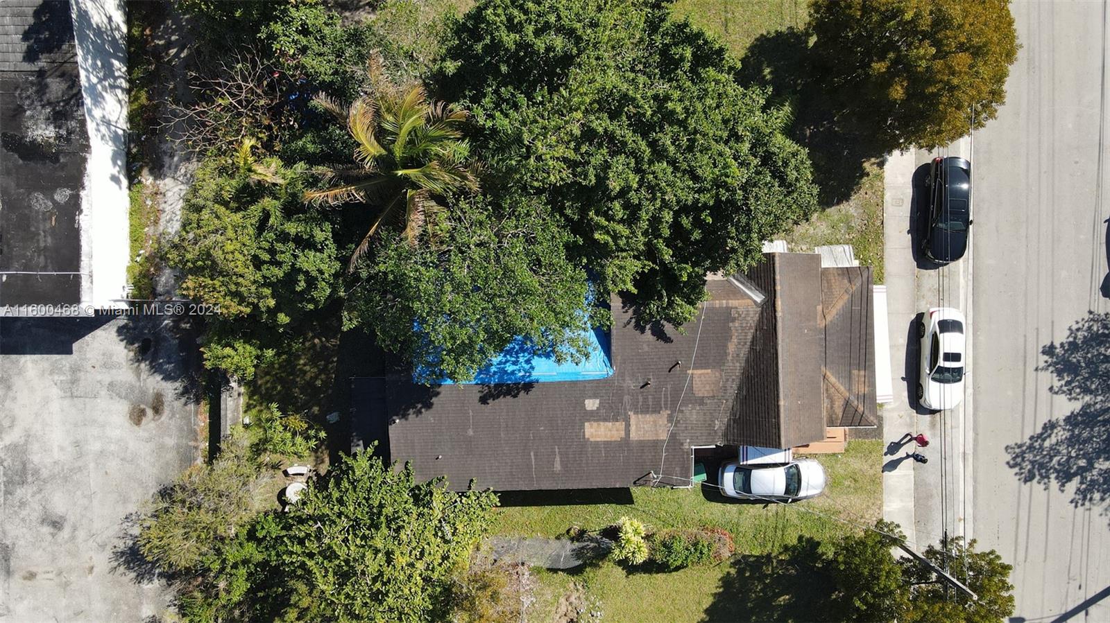 An aerial view shows a house with a blue tarp on the roof and three cars — 3373 Thomas Ave, Miami FL 33133, MIAMI, FL