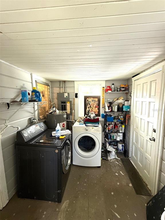 A laundry room features a dark washing machine, a white dryer, and open shelving — 1222 GOLCONDA ROAD, LAKELAND, FL