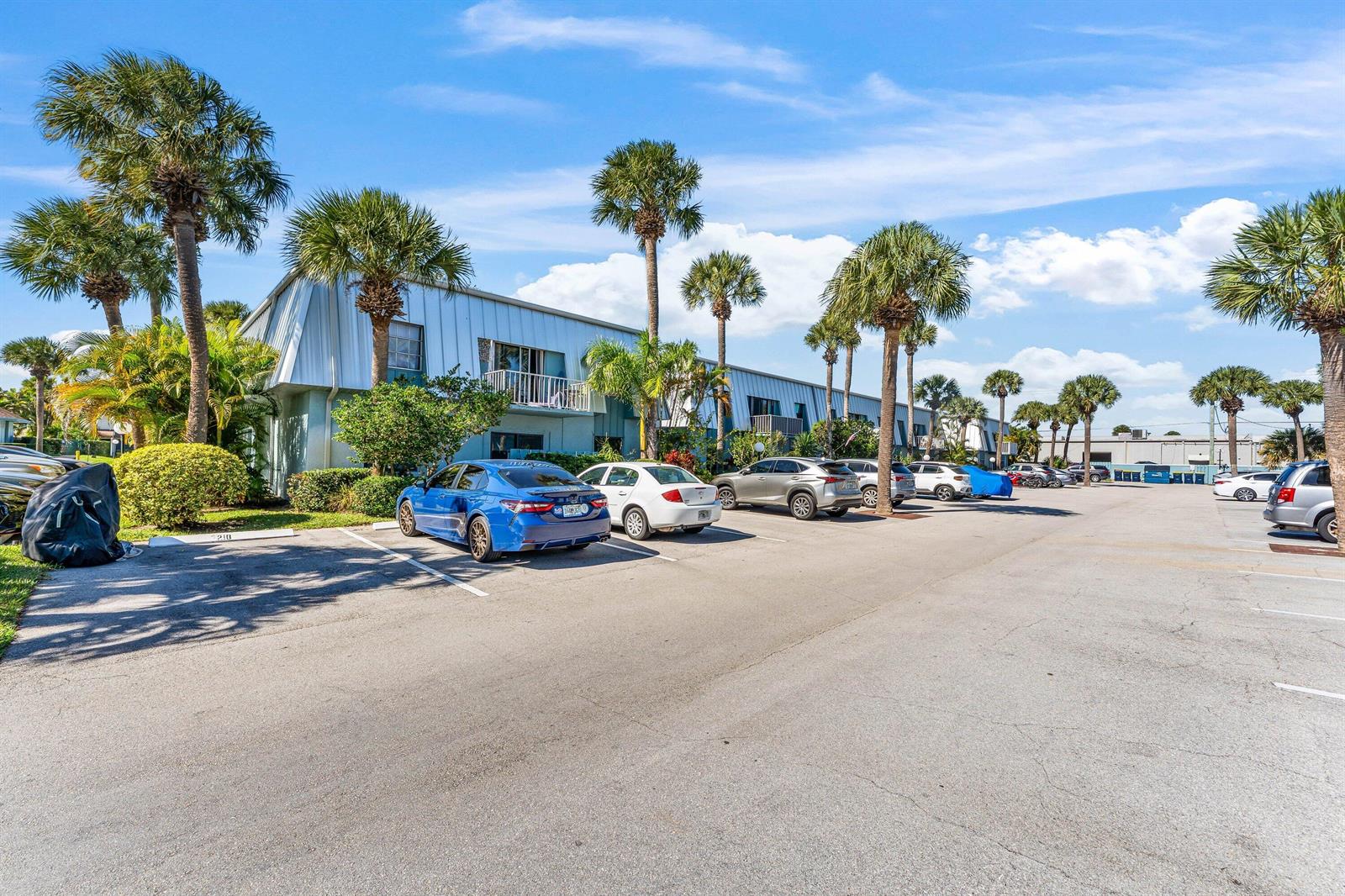 A two-story apartment building with a parking lot and palm trees in front — 950 S Kanner Highway # 10, Stuart FL 34994, STUART, FL