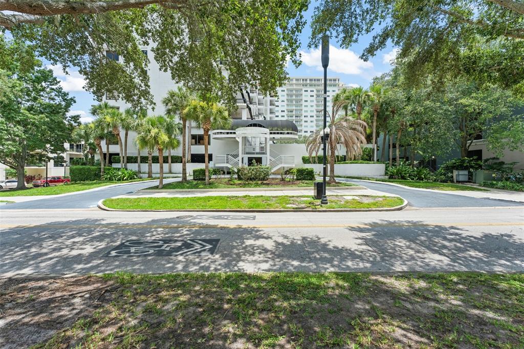 A multi-story residential building with a circular driveway and palm trees in the foreground — 530 E CENTRAL BOULEVARD UNIT 503, ORLANDO, FL