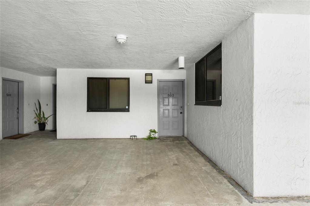 An exterior view shows a concrete walkway leading to two apartment doors numbered 501 and 503 — 530 E CENTRAL BOULEVARD UNIT 503, ORLANDO, FL