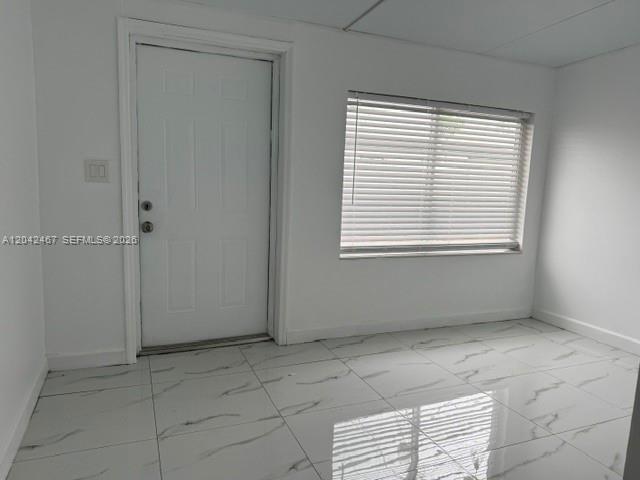 A room with white walls, a white door, and white marble-patterned tile flooring — 397 W 57th St # 3, Hialeah FL 33012, HIALEAH, FL