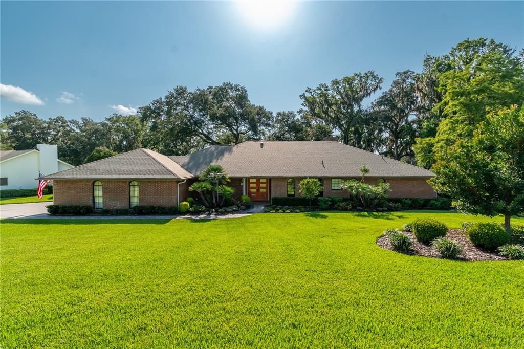 A single-story brick house with a hip roof and a large front lawn — 5101 NW 80TH AVENUE ROAD, OCALA, FL