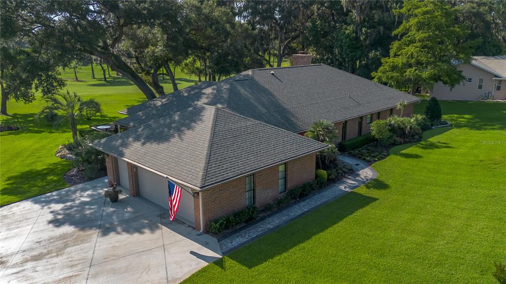 An aerial view of a brick house with a shingled roof and attached garage — 5101 NW 80TH AVENUE ROAD, OCALA, FL