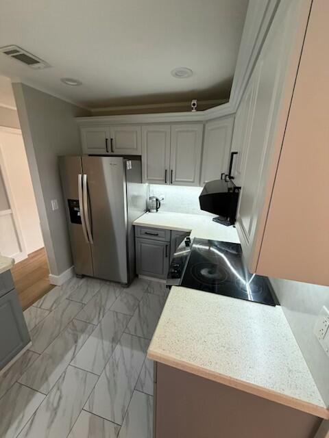 A kitchen features light gray cabinets, stainless steel appliances, and white marble-patterned tile flooring — 23153 SW 53rd Avenue, Boca Raton FL 33433, BOCA RATON, FL