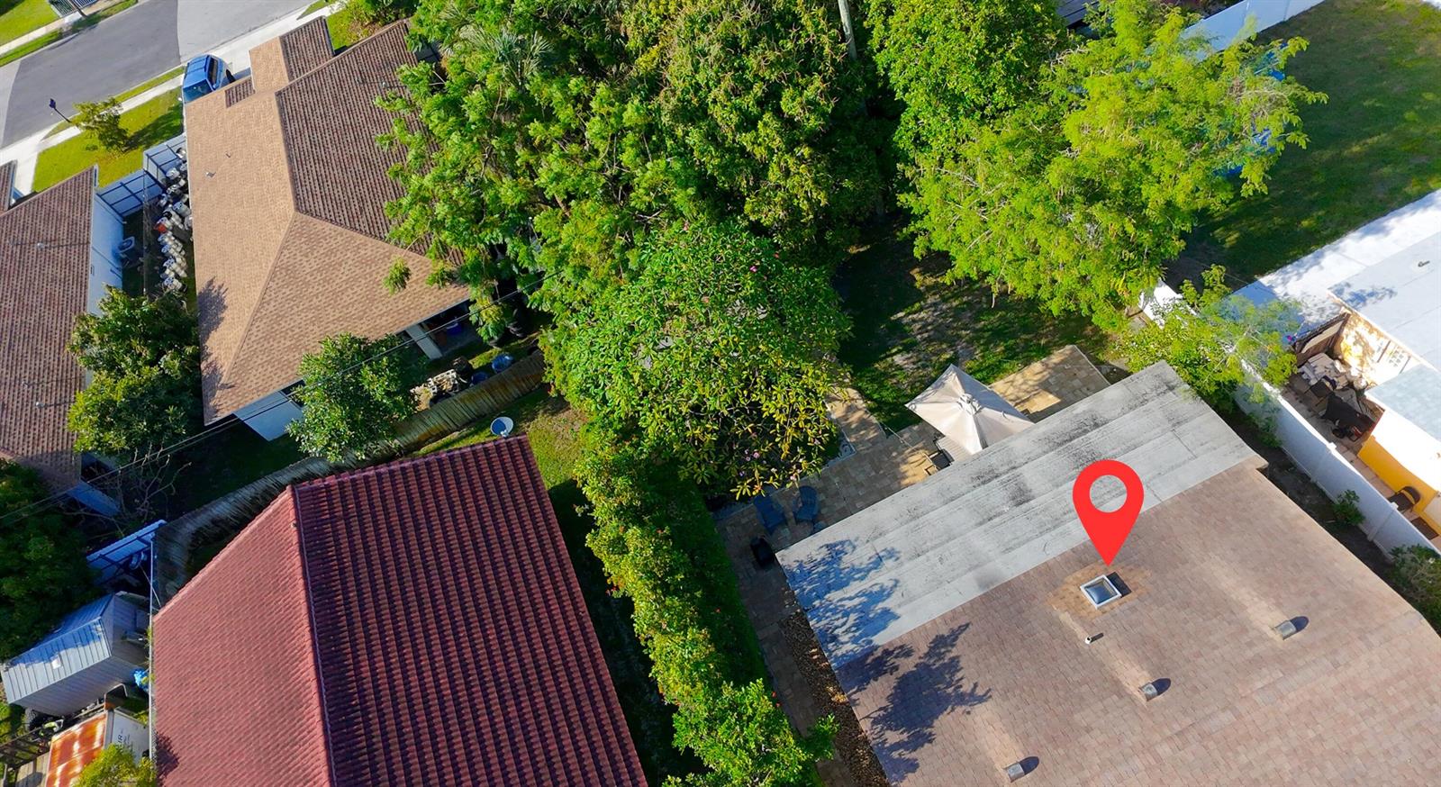 An aerial view shows a residential roof with a skylight and a nearby patio area — 429 Summa Street, West Palm Beach FL 33405, WEST PALM BEACH, FL