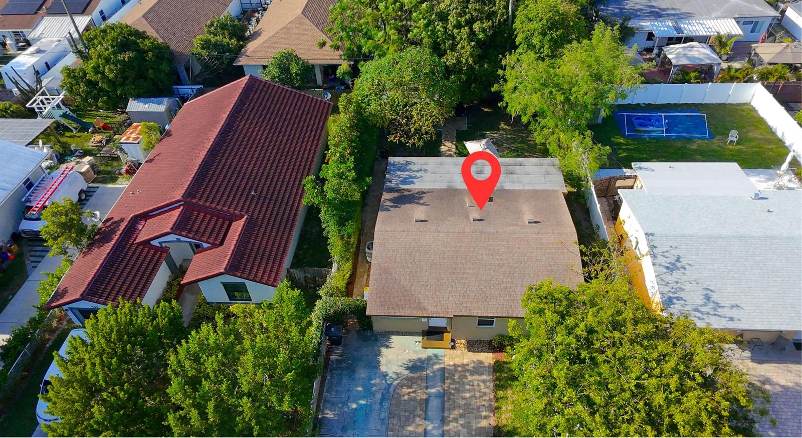 An aerial view shows a single-story house with a brown shingled roof and driveway — 429 Summa Street, West Palm Beach FL 33405, WEST PALM BEACH, FL