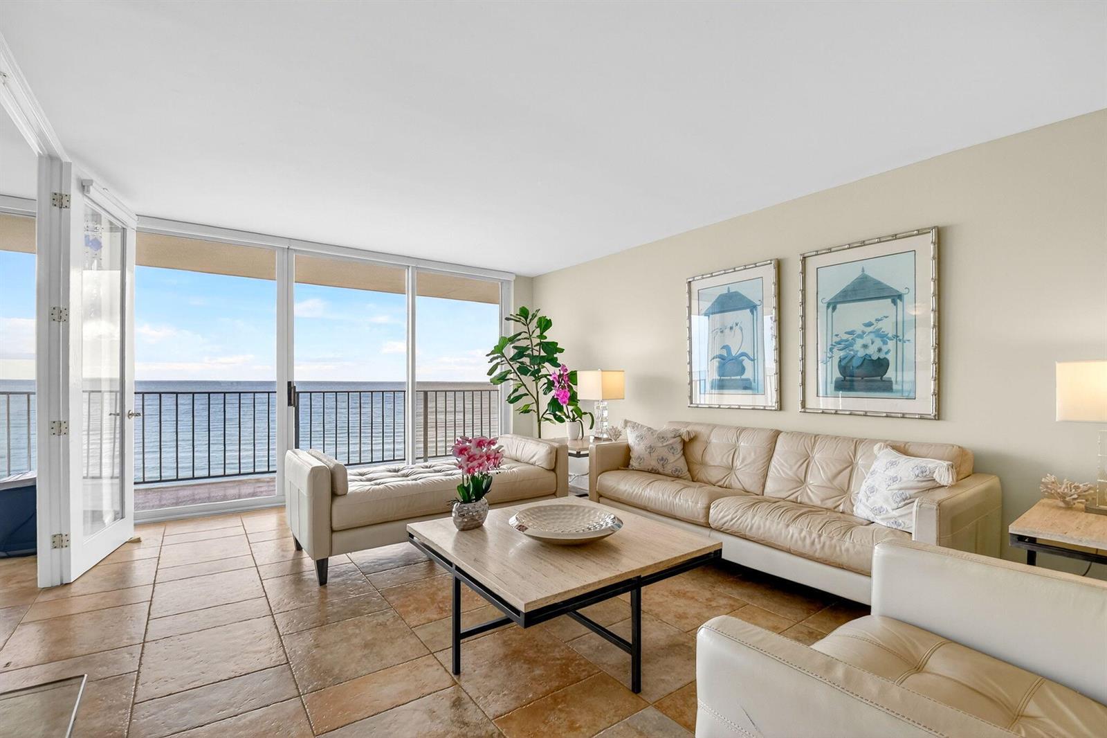 A living room features tile floors, a leather sofa, and a balcony overlooking the ocean — 3456 S Ocean Boulevard # 5020, Palm Beach FL 33480, PALM BEACH, FL