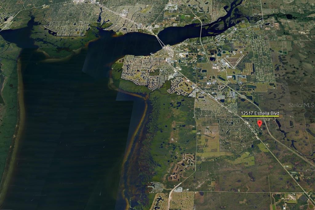 This is an aerial map view showing a residential area near a large body of water — 12517 ESTRELLA BOULEVARD, PUNTA GORDA, FL