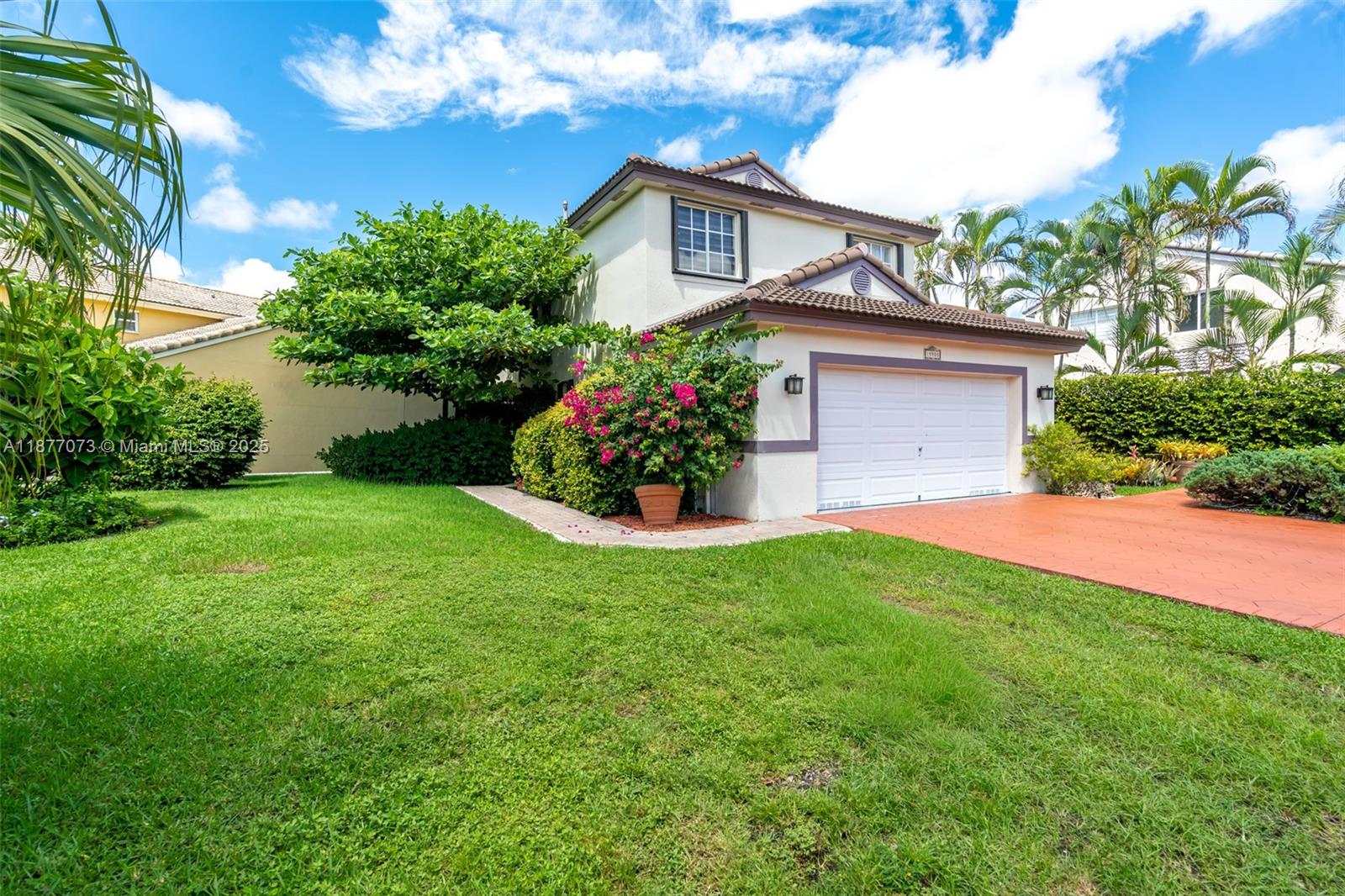 A two-story house with a white garage, a red driveway, and lush landscaping — 15905 SW 83rd Ter, Miami FL 33193, MIAMI, FL